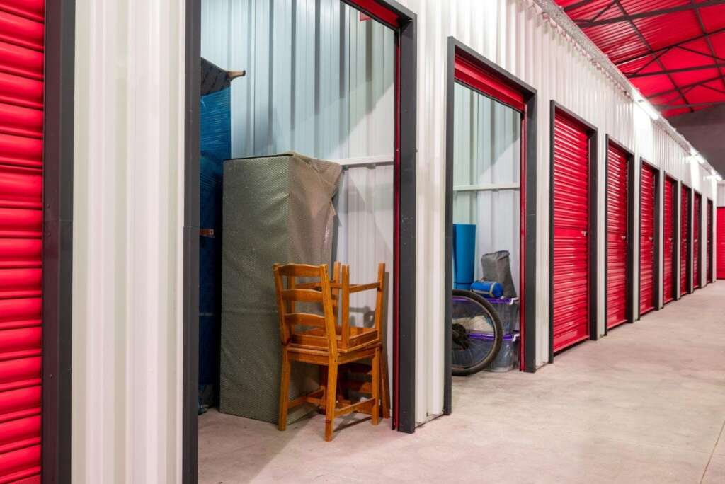 A storage facility with vibrant red doors and shutters creating a striking visual contrast