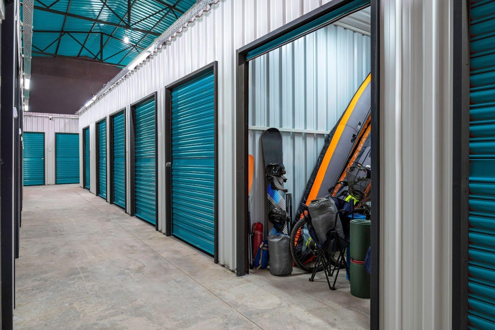 A row of storage units at a storage center showcasing various sizes and colors for rental