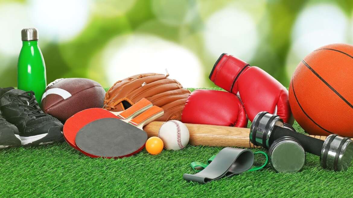 A variety of sports equipment, including balls and bats, arranged on grass, highlighting secure self-storage options.