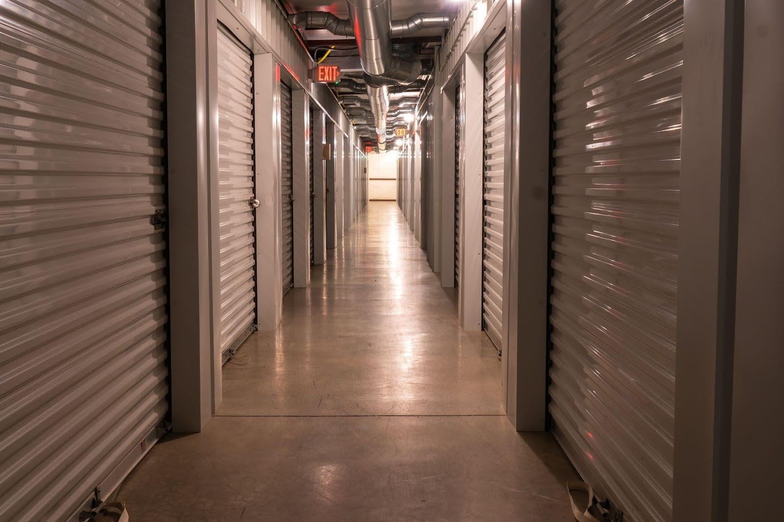 Indoor storage facility hallway with metal roll-up units