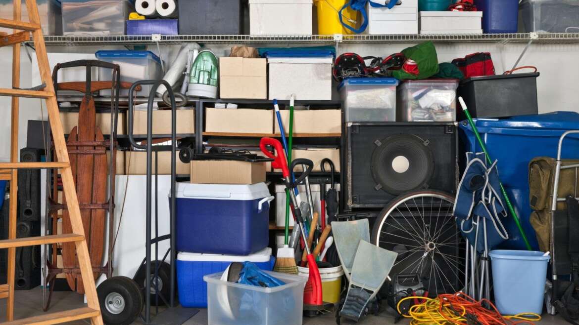 A spacious garage showcasing bicycles tools and storage bins creating a busy environment