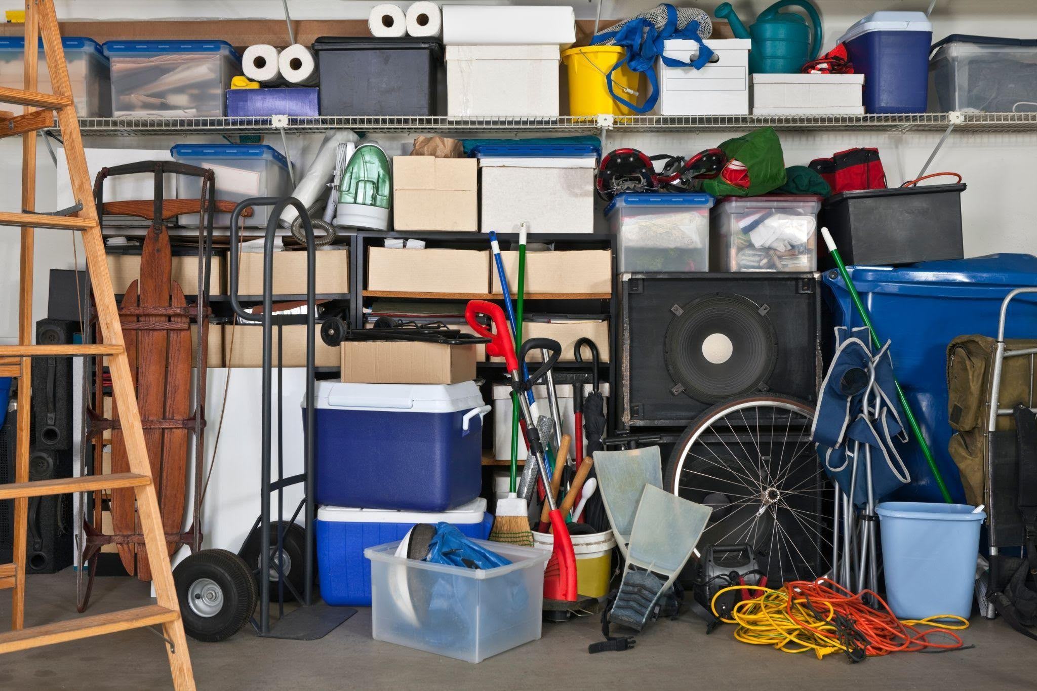 A spacious garage showcasing bicycles tools and storage bins creating a busy environment